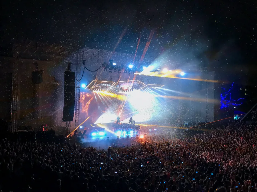 Crowd in front of an illuminated concert stage