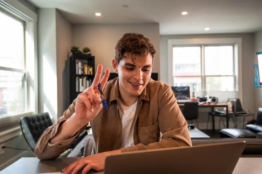 Man working on a laptop in a bright office