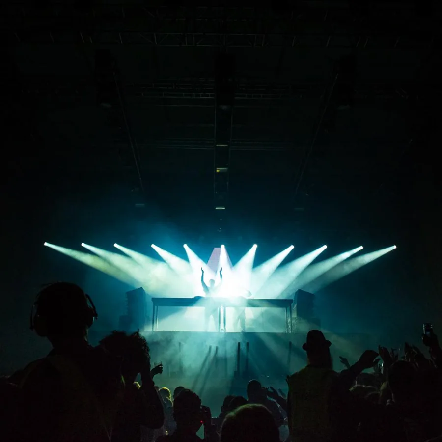 Stage lighting rig glowing above the audience
